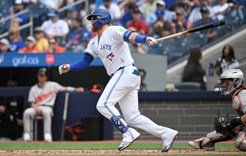 Jun 6, 2024; Toronto, Ontario, CAN;   Toronto Blue Jays designated hitter Justin Turner (2) hits a single against the Baltimore Orioles in the eighth inning at Rogers Centre. Mandatory Credit: Dan Hamilton-USA TODAY Sports