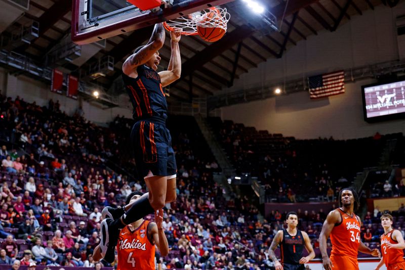 Jan 4, 2025; Blacksburg, Virginia, USA; Miami Hurricanes guard Matthew Cleveland (0) dunks the ball during the second half against the Virginia Tech Hokies at Cassell Coliseum. Mandatory Credit: Peter Casey-Imagn Images