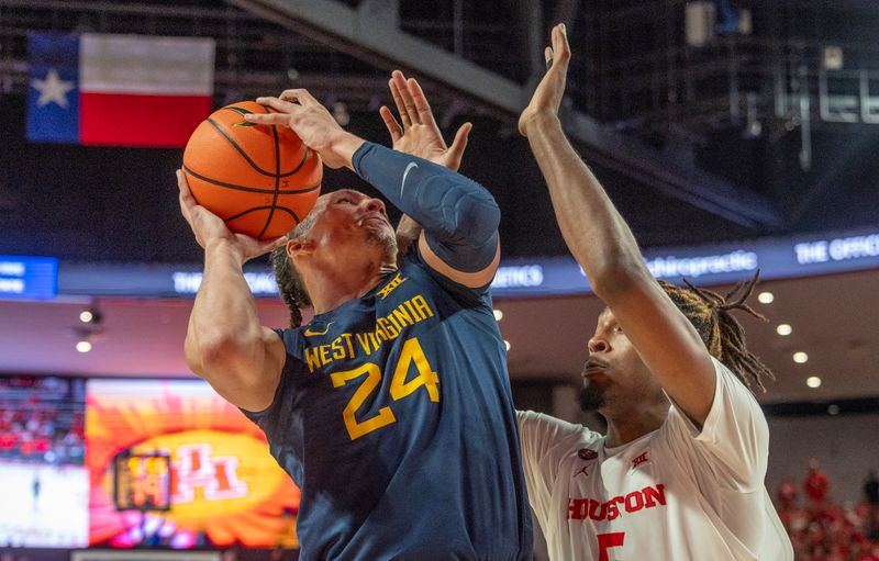 Jan 6, 2024; Houston, Texas, USA; West Virginia Mountaineers forward Patrick Suemnick (24) shoots against Houston Cougars forward Ja'Vier Francis (5) in the first half  at Fertitta Center. Mandatory Credit: Thomas Shea-USA TODAY Sports