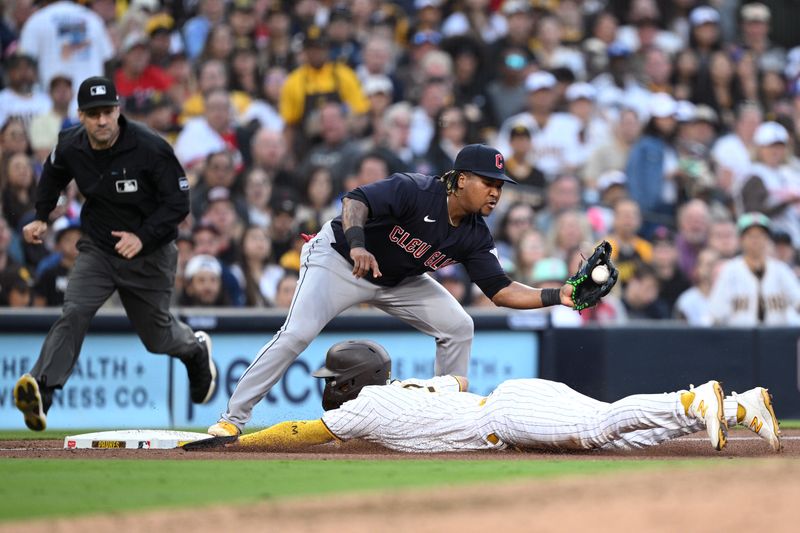 Jun 15, 2023; San Diego, California, USA; San Diego Padres second baseman Ha-seong Kim (7) slides into third base ahead of the tag by Cleveland Guardians third baseman Jose Ramirez (11) during the fifth inning at Petco Park. Mandatory Credit: Orlando Ramirez-USA TODAY Sports