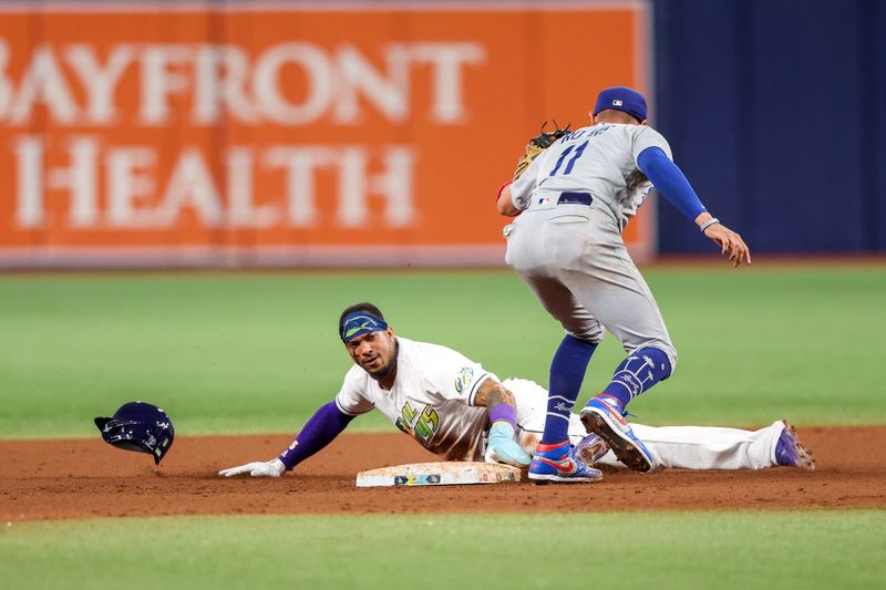 May 26, 2023; St. Petersburg, Florida, USA;  Tampa Bay Rays shortstop Wander Franco (5) steals second base from Los Angeles Dodgers shortstop Miguel Rojas (11) in the seventh inning at Tropicana Field. Mandatory Credit: Nathan Ray Seebeck-USA TODAY Sports