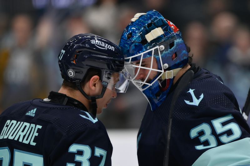 Dec 12, 2023; Seattle, Washington, USA; Seattle Kraken center Yanni Gourde (37) and goaltender Joey Daccord (35) celebrate after defeating the Florida Panthers at Climate Pledge Arena. Mandatory Credit: Steven Bisig-USA TODAY Sports.