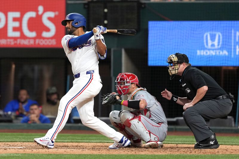 Sep 7, 2024; Arlington, Texas, USA; Texas Rangers second baseman Marcus Semien (2) follows through on his RBI single against the Los Angeles Angels during the seventh inning at Globe Life Field. Mandatory Credit: Jim Cowsert-Imagn Images