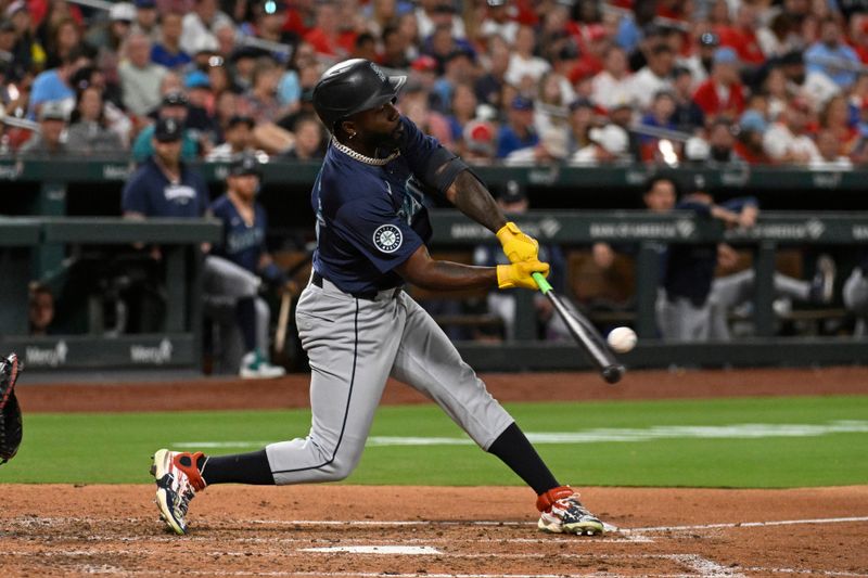 Sep 6, 2024; St. Louis, Missouri, USA; Seattle Mariners left fielder Randy Arozarena (56) hits a sacrifice fly against the St. Louis Cardinals in the fifth inning at Busch Stadium. Mandatory Credit: Joe Puetz-Imagn Images