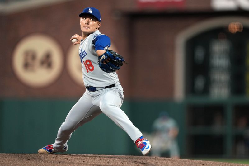 Sep 12, 2025; San Francisco, California, USA; Los Angeles Dodgers pitcher Yoshinobu Yamamoto (18) throws a pitch against the San Francisco Giants during the first inning at Oracle Park. Mandatory Credit: Darren Yamashita-Imagn Images