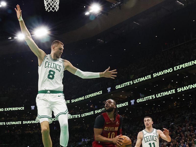 BOSTON, MA - DECEMBER 14: Darius Garland #10 of the Cleveland Cavaliers looks for a way past Kristaps Porzingis #8 of the Boston Celtics during the second quarter at TD Garden on December 14, 2023 in Boston, Massachusetts. NOTE TO USER: User expressly acknowledges and agrees that, by downloading and/or using this Photograph, user is consenting to the terms and conditions of the Getty Images License Agreement. (Photo By Winslow Townson/Getty Images)