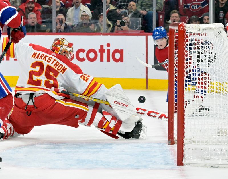 Nov 14, 2023; Montreal, Quebec, CAN; Calgary Flames goalie Jacob Markstrom (25) stops Montreal Canadiens forward Cole Caufield (22) during the third period at the Bell Centre. Mandatory Credit: Eric Bolte-USA TODAY Sports