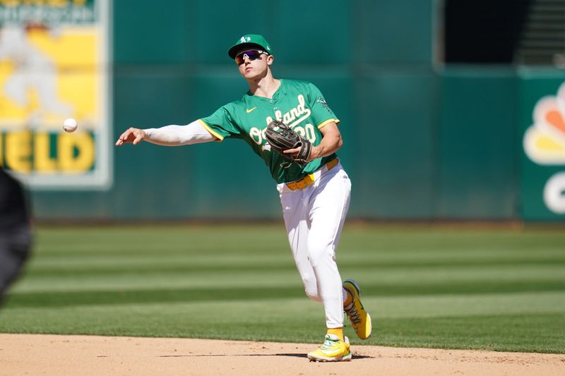 Sep 22, 2024; Oakland, California, USA; Oakland Athletics second baseman Zack Gelof (20) throws the ball to first to record an out against the New York Yankees in the fifth inning at the Oakland-Alameda County Coliseum. Mandatory Credit: Cary Edmondson-Imagn Images