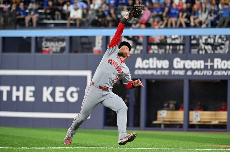 Aug 19, 2024; Toronto, Ontario, CAN; Cincinnati Reds right fielder Jake Fraley (27) makes a running catch of a popup foul hit by Toronto Blue Jays right fielder George Springer (not shown) in the seventh inning at Rogers Centre. Mandatory Credit: Dan Hamilton-USA TODAY Sports