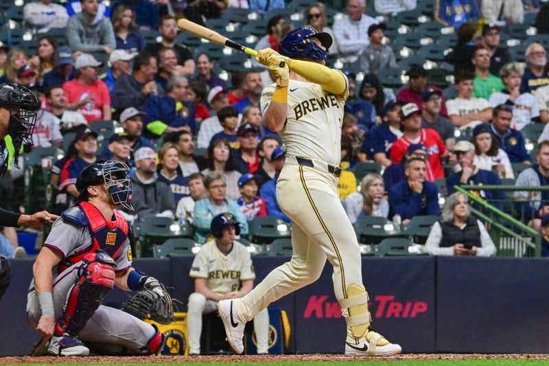 Jun 10, 2025; Milwaukee, Wisconsin, USA;  Milwaukee Brewers designated hitter Jake Bauers (9) hits a solo home run in the sixth inning as Atlanta Braves catcher Sean Murphy (12) looks on at American Family Field. Mandatory Credit: Benny Sieu-Imagn Images