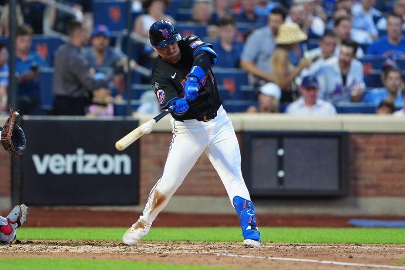 Jul 10, 2024; New York City, New York, USA; New York Mets second baseman Jose Iglesias (11) hits a single against the Washington Nationals during the fourth inning at Citi Field. Mandatory Credit: Gregory Fisher-USA TODAY Sports