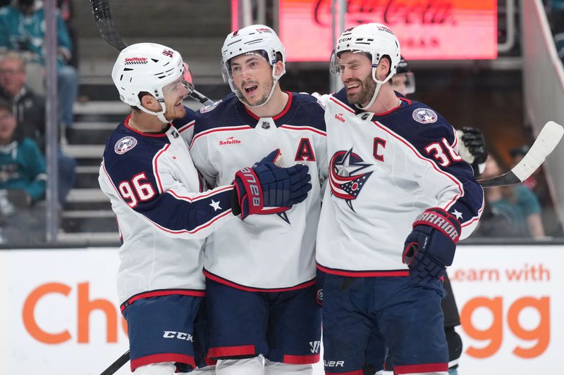 Feb 17, 2024; San Jose, California, USA; Columbus Blue Jackets defenseman Zach Werenski (center) celebrates with center Jack Roslovic (96) and center Boone Jenner (38) after scoring a goal against the San Jose Sharks during the first period at SAP Center at San Jose. Mandatory Credit: Darren Yamashita-USA TODAY Sports