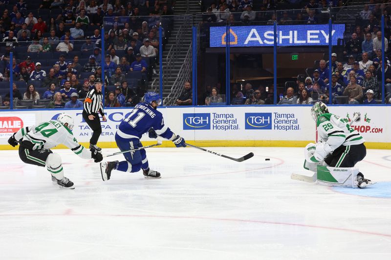 Dec 4, 2023; Tampa, Florida, USA; Tampa Bay Lightning center Luke Glendening (11) scores a goal past Dallas Stars defenseman Joel Hanley (44) on goaltender Jake Oettinger (29)  during the third period at Amalie Arena. Mandatory Credit: Kim Klement Neitzel-USA TODAY Sports