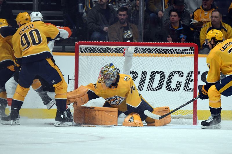 Dec 12, 2023; Nashville, Tennessee, USA; Nashville Predators goaltender Juuse Saros (74) makes a save during the first period against the Philadelphia Flyers at Bridgestone Arena. Mandatory Credit: Christopher Hanewinckel-USA TODAY Sports