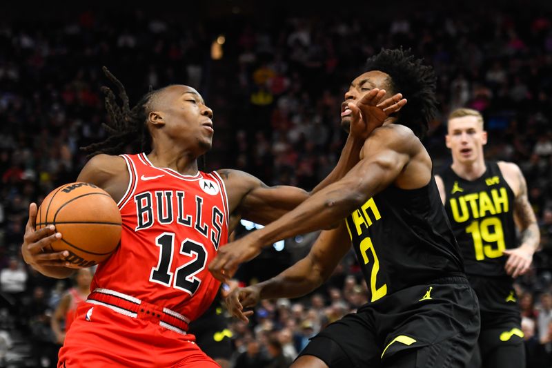 SALT LAKE CITY, UTAH - MARCH 06: Ayo Dosunmu #12 of the Chicago Bulls drives into Collin Sexton #2 of the Utah Jazz during the first half of a game at Delta Center on March 06, 2024 in Salt Lake City, Utah. NOTE TO USER: User expressly acknowledges and agrees that, by downloading and or using this photograph, User is consenting to the terms and conditions of the Getty Images License Agreement.  (Photo by Alex Goodlett/Getty Images)