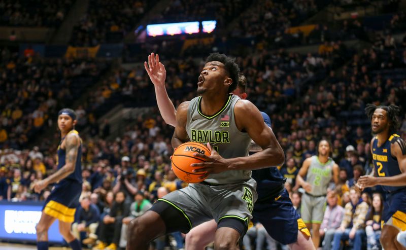 Feb 17, 2024; Morgantown, West Virginia, USA; Baylor Bears center Yves Missi (21) makes a move in the lane during the first half against the West Virginia Mountaineers at WVU Coliseum. Mandatory Credit: Ben Queen-USA TODAY Sports