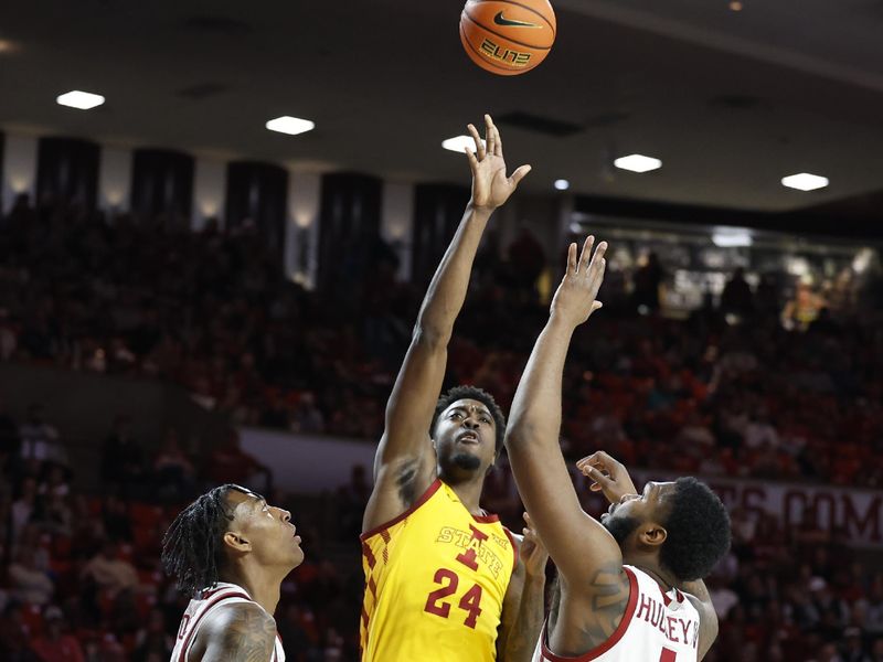 Jan 6, 2024; Norman, Oklahoma, USA; Iowa State Cyclones forward Hason Ward (24) shoots between Oklahoma Sooners forward Jalon Moore (14) and forward John Hugley IV (1) and  during the first half at Lloyd Noble Center. Mandatory Credit: Alonzo Adams-USA TODAY Sports