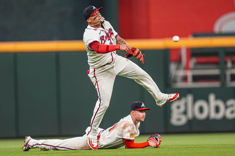 May 14, 2024; Cumberland, Georgia, USA; Atlanta Braves shortstop Orlando Arcia (11) throws after fielding a ball hit by Chicago Cubs third baseman Patrick Wisdom (16) (not shown) during the eighth inning at Truist Park. Mandatory Credit: Dale Zanine-USA TODAY Sports