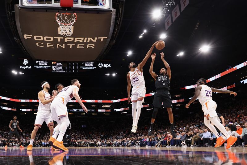 PHOENIX, ARIZONA - DECEMBER 13: Mikal Bridges #1 of the Brooklyn Nets has his shot blocked by Kevin Durant #35 of the Phoenix Suns during the first half of the NBA game at Footprint Center on December 13, 2023 in Phoenix, Arizona.The Nets defeated the Suns 116-112. NOTE TO USER: User expressly acknowledges and agrees that, by downloading and or using this photograph, User is consenting to the terms and conditions of the Getty Images License Agreement.  (Photo by Christian Petersen/Getty Images)