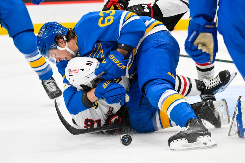 Oct 15, 2025; St. Louis, Missouri, USA; St. Louis Blues left wing Jake Neighbours (63) fights Chicago Blackhawks center Frank Nazar (91) after he scored and collided with goaltender Joel Hofer (not pictured) during the second period at Enterprise Center. Mandatory Credit: Jeff Curry-Imagn Images