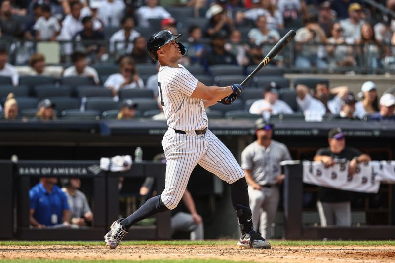 Aug 25, 2024; Bronx, New York, USA;  New York Yankees designated hitter Giancarlo Stanton (27) hits a solo home run in the seventh inning against the Colorado Rockies at Yankee Stadium. Mandatory Credit: Wendell Cruz-USA TODAY Sports