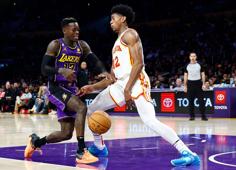 LOS ANGELES, CALIFORNIA - JANUARY 06:  Dennis Schroder #17 of the Los Angeles Lakers controls the ball against De'Andre Hunter #12 of the Atlanta Hawks in the second half at Crypto.com Arena on January 06, 2023 in Los Angeles, California.  NOTE TO USER: User expressly acknowledges and agrees that, by downloading and/or using this photograph, user is consenting to the terms and conditions of the Getty Images License Agreement.  (Photo by Ronald Martinez/Getty Images)