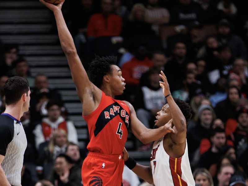 TORONTO, CANADA - JANUARY 17: Scottie Barnes #4 of the Toronto Raptors is defended by Kyle Lowry #7 of the Miami Heat during the first half at Scotiabank Arena on January 17, 2024 in Toronto, Canada. NOTE TO USER: User expressly acknowledges and agrees that, by downloading and or using this photograph, User is consenting to the terms and conditions of the Getty Images License Agreement. (Photo by Cole Burston/Getty Images)