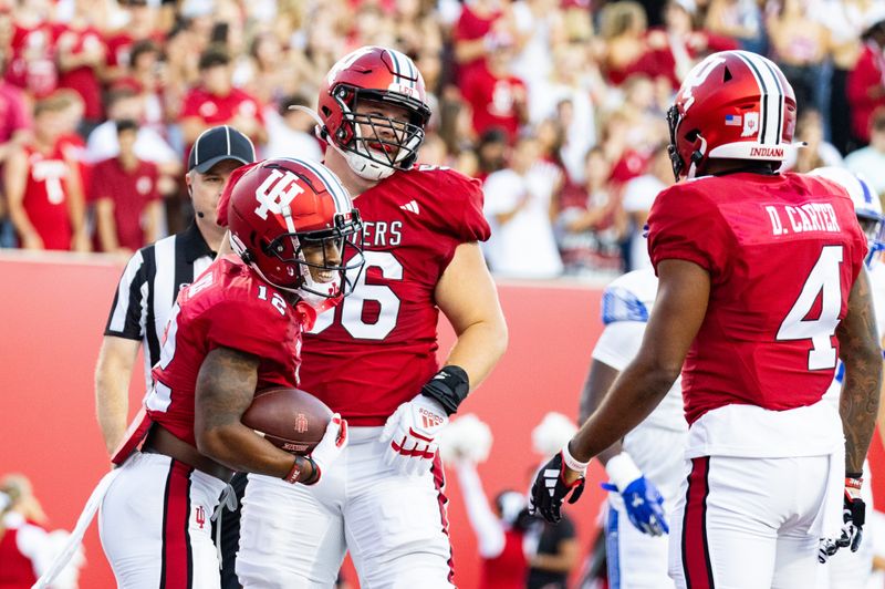 Sep 8, 2023; Bloomington, Indiana, USA; Indiana Hoosiers running back Jaylin Lucas (12) celebrates his touchdown with tight end Brody Foley (86) in the first half against the Indiana State Sycamores at Memorial Stadium. Mandatory Credit: Trevor Ruszkowski-USA TODAY Sports