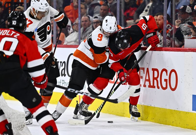 Apr 13, 2024; Philadelphia, Pennsylvania, USA; Philadelphia Flyers defenseman Jamie Drysdale (9) and New Jersey Devils defenseman John Marino (6) battle for the puck in the second period at Wells Fargo Center. Mandatory Credit: Kyle Ross-USA TODAY Sports