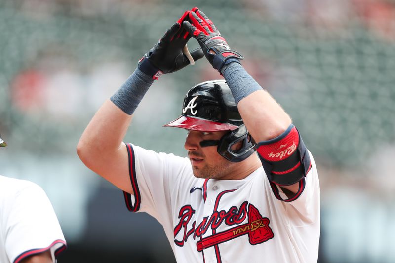 Aug 4, 2024; Cumberland, Georgia, USA; Atlanta Braves third baseman Austin Riley (27) celebrates his single in a game against the Miami Marlins in the sixth inning at Truist Park. Mandatory Credit: Mady Mertens-USA TODAY Sports