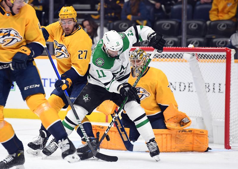 Oct 13, 2022; Nashville, Tennessee, USA; Dallas Stars center Luke Glendening (11) deflects a shot on Nashville Predators goaltender Juuse Saros (74) during the second period at Bridgestone Arena. Mandatory Credit: Christopher Hanewinckel-USA TODAY Sports