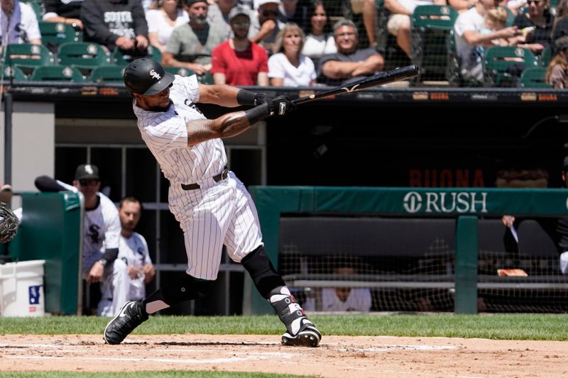 Jun 30, 2024; Chicago, Illinois, USA; Chicago White Sox outfielder Corey Julks (30) hits a single against the Colorado Rockies during the third inning at Guaranteed Rate Field. Mandatory Credit: David Banks-USA TODAY Sports