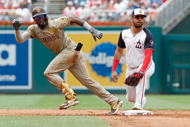 Jul 25, 2024; Washington, District of Columbia, USA; San Diego Padres outfielder Jurickson Profar (10) advances to third base after a throw bounces past Washington Nationals second baseman Luis García Jr. (2) at second base during the second inning at Nationals Park. Mandatory Credit: Geoff Burke-USA TODAY Sports