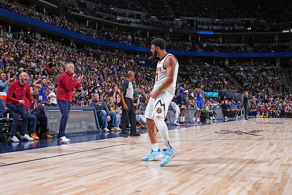 DENVER, CO - DECEMBER 25: Jamal Murray #27 of the Denver Nuggets celebrates during the game against the Golden State Warriors on December 25, 2023 at the Ball Arena in Denver, Colorado. NOTE TO USER: User expressly acknowledges and agrees that, by downloading and/or using this Photograph, user is consenting to the terms and conditions of the Getty Images License Agreement. Mandatory Copyright Notice: Copyright 2023 NBAE (Photo by Garrett Ellwood/NBAE via Getty Images)