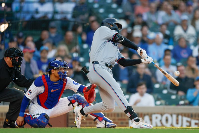 May 14, 2025; Chicago, Illinois, USA; Miami Marlins center fielder Kyle Stowers (28) hits a solo home run against the Chicago Cubs during the second inning at Wrigley Field. Mandatory Credit: Kamil Krzaczynski-Imagn Images