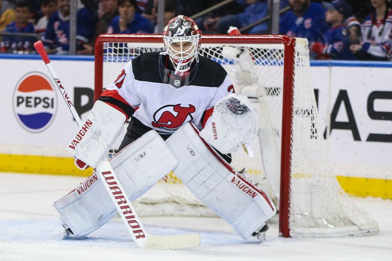 Apr 3, 2024; New York, New York, USA; New Jersey Devils goaltender Kaapo Kahkonen (31) defends the net in the first period against the New York Rangers at Madison Square Garden. Mandatory Credit: Wendell Cruz-USA TODAY Sports