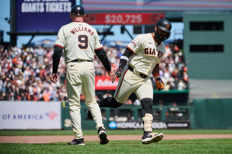 May 19, 2024; San Francisco, California, USA; San Francisco Giants outfielder Heliot Ramos (17) shakes hands with San Francisco Giants third base coach Matt Williams (9) after hitting a one run home run against the Colorado Rockies during the sixth inning at Oracle Park. Mandatory Credit: Robert Edwards-USA TODAY Sports