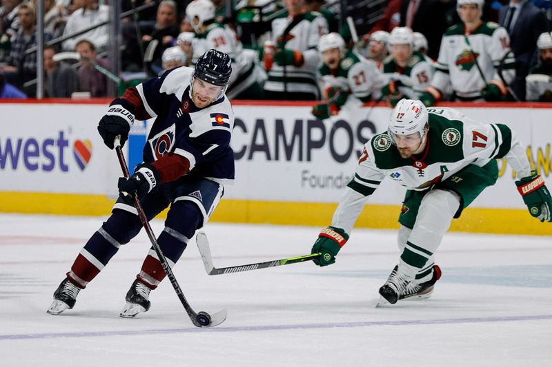 Mar 8, 2024; Denver, Colorado, USA; Colorado Avalanche defenseman Devon Toews (7) controls the puck ahead of Minnesota Wild left wing Marcus Foligno (17) in the second period at Ball Arena. Mandatory Credit: Isaiah J. Downing-USA TODAY Sports