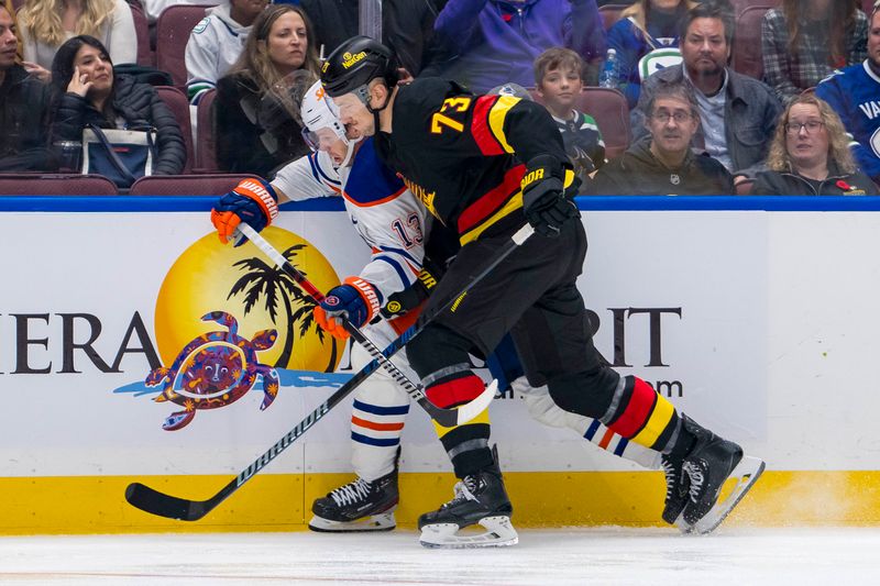 Nov 9, 2024; Vancouver, British Columbia, CAN; Vancouver Canucks defenseman Vincent Desharnais (73) checks Edmonton Oilers forward Mattias Janmark (13) during the third period at Rogers Arena. Mandatory Credit: Bob Frid-Imagn Images