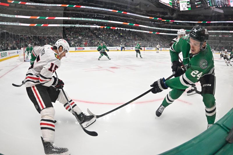 Nov 7, 2024; Dallas, Texas, USA; Chicago Blackhawks center Craig Smith (15) and Dallas Stars center Roope Hintz (24) battle for control of the puck during the first period at the American Airlines Center. Mandatory Credit: Jerome Miron-Imagn Images