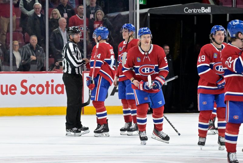 Apr 2, 2024; Montreal, Quebec, CAN; Montreal Canadiens forward Nick Suzuki (14) and teammates exchange words with linesman Jonny Murray (95) after the game against the Florida Panthers at the Bell Centre. Mandatory Credit: Eric Bolte-USA TODAY Sports