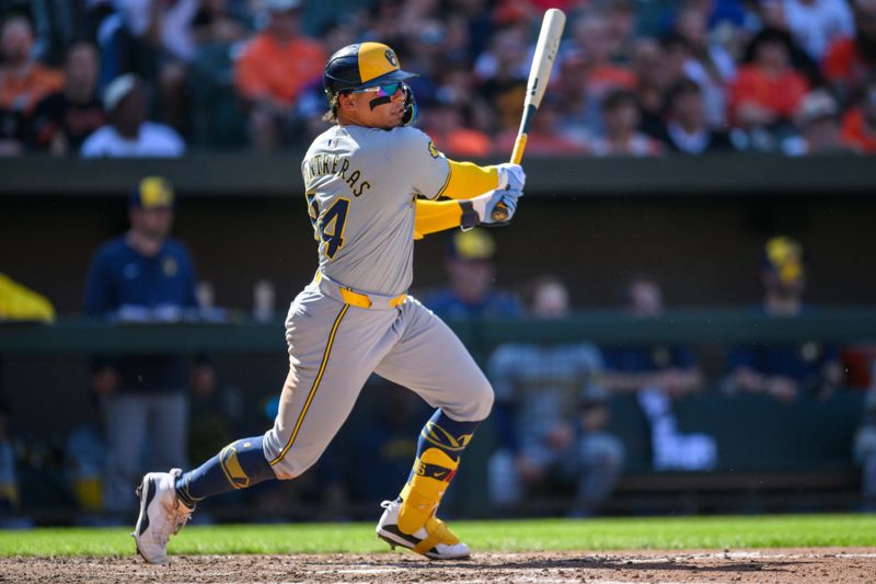 Apr 14, 2024; Baltimore, Maryland, USA; Milwaukee Brewers catcher William Contreras (24) hits a single during the ninth inning against the Baltimore Orioles at Oriole Park at Camden Yards. Mandatory Credit: Reggie Hildred-USA TODAY Sports