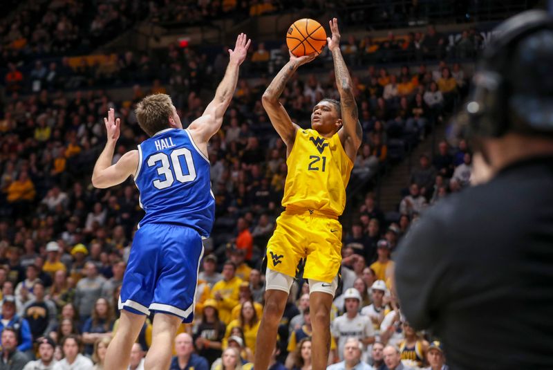 Feb 3, 2024; Morgantown, West Virginia, USA; West Virginia Mountaineers guard RaeQuan Battle (21) shoots a jumper over Brigham Young Cougars guard Dallin Hall (30) during the second half at WVU Coliseum. Mandatory Credit: Ben Queen-USA TODAY Sports