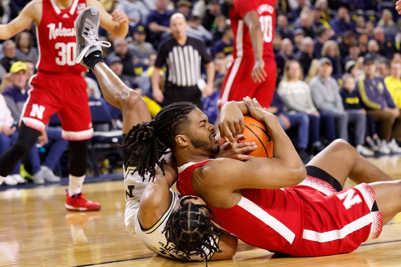 Feb 8, 2023; Ann Arbor, Michigan, USA;  Michigan Wolverines guard Kobe Bufkin (2) and Nebraska Cornhuskers forward Derrick Walker (13) tie up the ball in the first half at Crisler Center. Mandatory Credit: Rick Osentoski-USA TODAY Sports