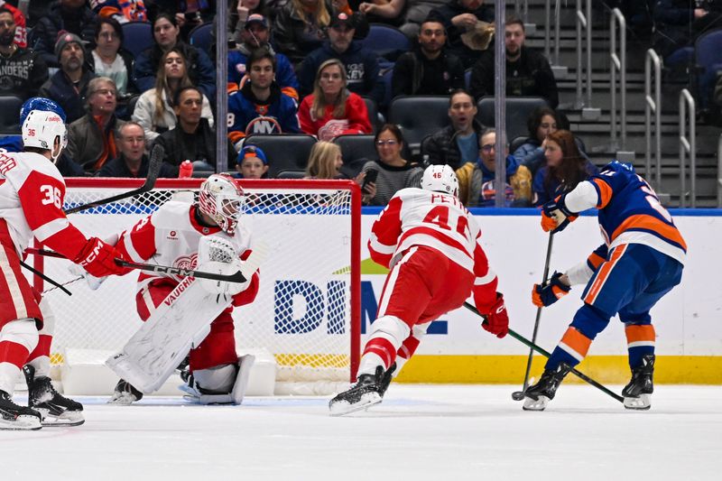 Nov 25, 2024; Elmont, New York, USA;  New York Islanders center Mathew Barzal (13) scores a goal past Detroit Red Wings goaltender Alex Lyon (34) during the second period at UBS Arena. Mandatory Credit: Dennis Schneidler-Imagn Images