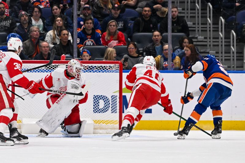 Nov 25, 2024; Elmont, New York, USA;  New York Islanders center Mathew Barzal (13) scores a goal past Detroit Red Wings goaltender Alex Lyon (34) during the second period at UBS Arena. Mandatory Credit: Dennis Schneidler-Imagn Images