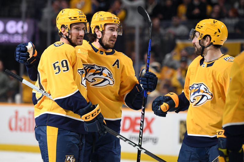 Mar 19, 2024; Nashville, Tennessee, USA; Nashville Predators defenseman Roman Josi (59) celebrates with defenseman Ryan McDonagh (27) and left wing Filip Forsberg (9) during the first period against the San Jose Sharks at Bridgestone Arena. Mandatory Credit: Christopher Hanewinckel-USA TODAY Sports