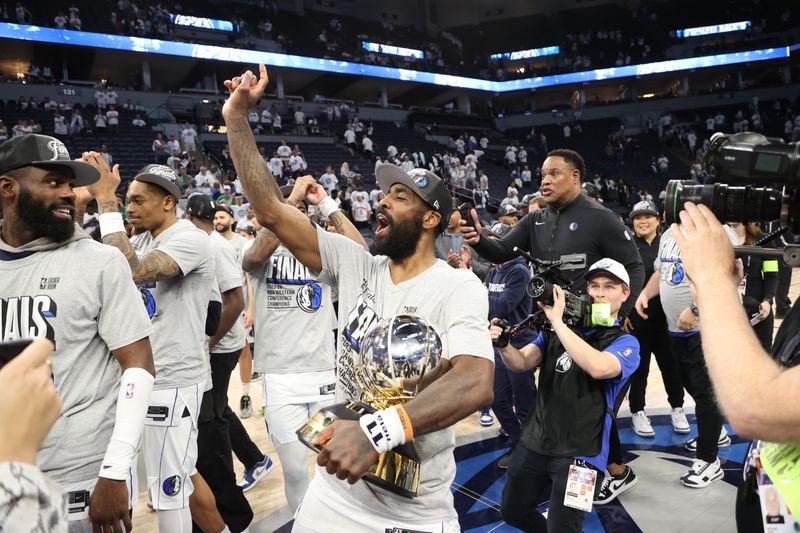 MINNEAPOLIS, MN - MAY 30: Kyrie Irving #11 of the Dallas Mavericks celebrates with the Oscar Robertson Trophy after winning the Western Conference Finals during Round 3 Game 5 of the 2024 NBA Playoffs on May 30, 2024 at Target Center in Minneapolis, Minnesota. NOTE TO USER: User expressly acknowledges and agrees that, by downloading and or using this Photograph, user is consenting to the terms and conditions of the Getty Images License Agreement. Mandatory Copyright Notice: Copyright 2024 NBAE (Photo by Joe Murphy/NBAE via Getty Images)