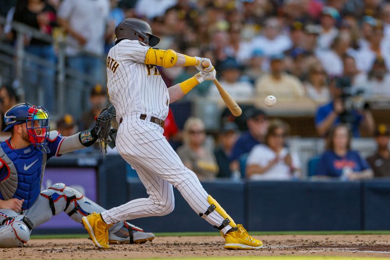 Jul 29, 2023; San Diego, California, USA;  San Diego Padres first baseman Jake Cronenworth (9) singles to center field in the second inning against the Texas Rangers at Petco Park. Mandatory Credit: David Frerker-USA TODAY Sports