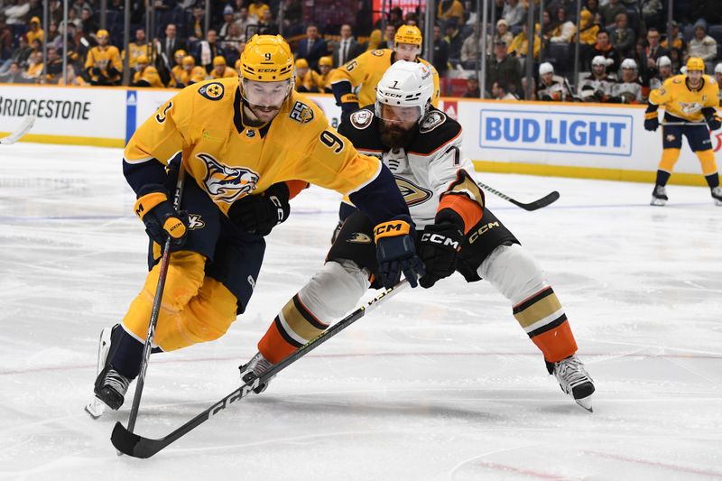 Jan 9, 2024; Nashville, Tennessee, USA; Nashville Predators left wing Filip Forsberg (9) handles the puck against Anaheim Ducks defenseman Radko Gudas (7) during the third period at Bridgestone Arena. Mandatory Credit: Christopher Hanewinckel-USA TODAY Sports